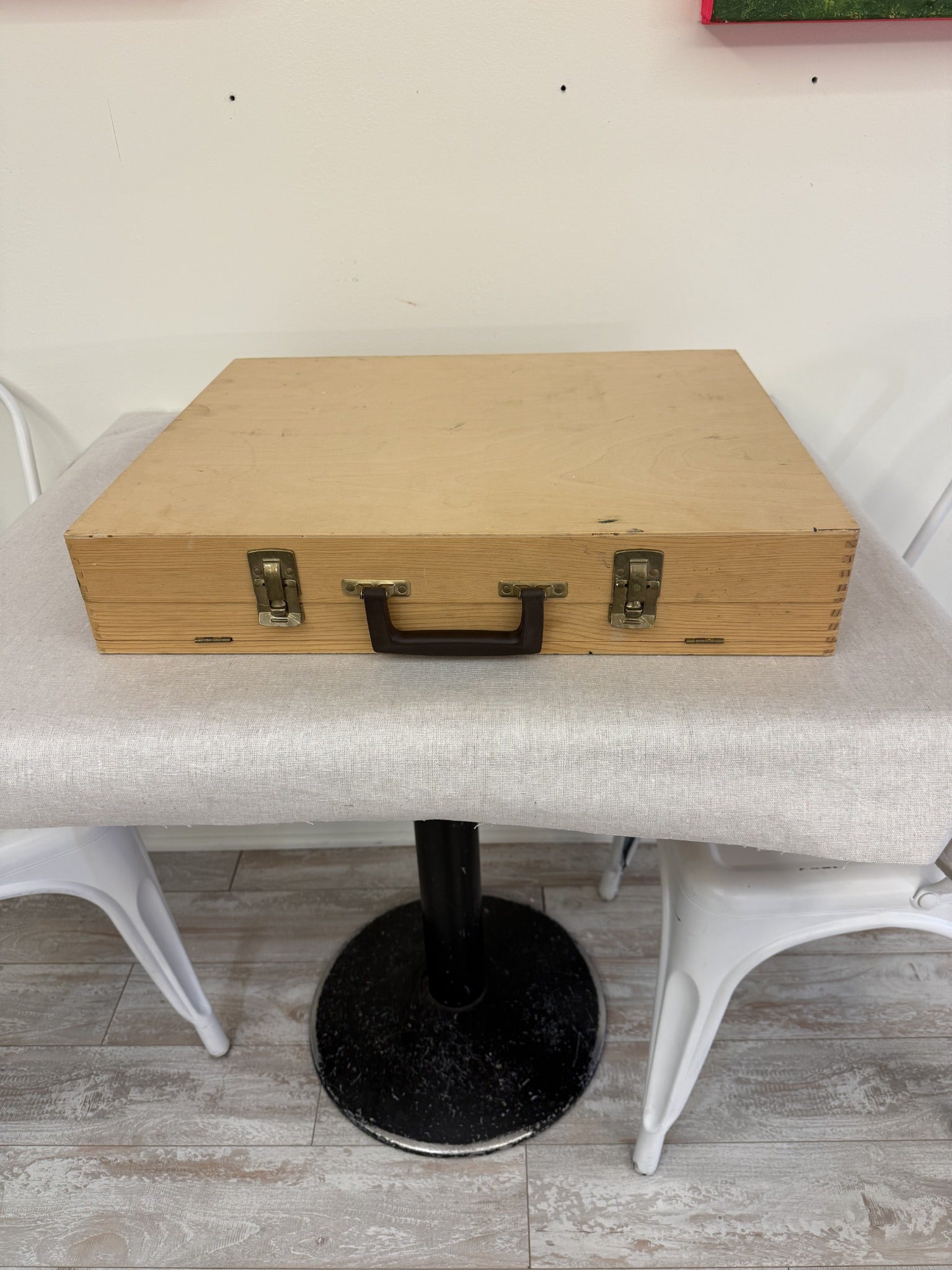 Wooden artist supply carrying case closed with handle and metal latches